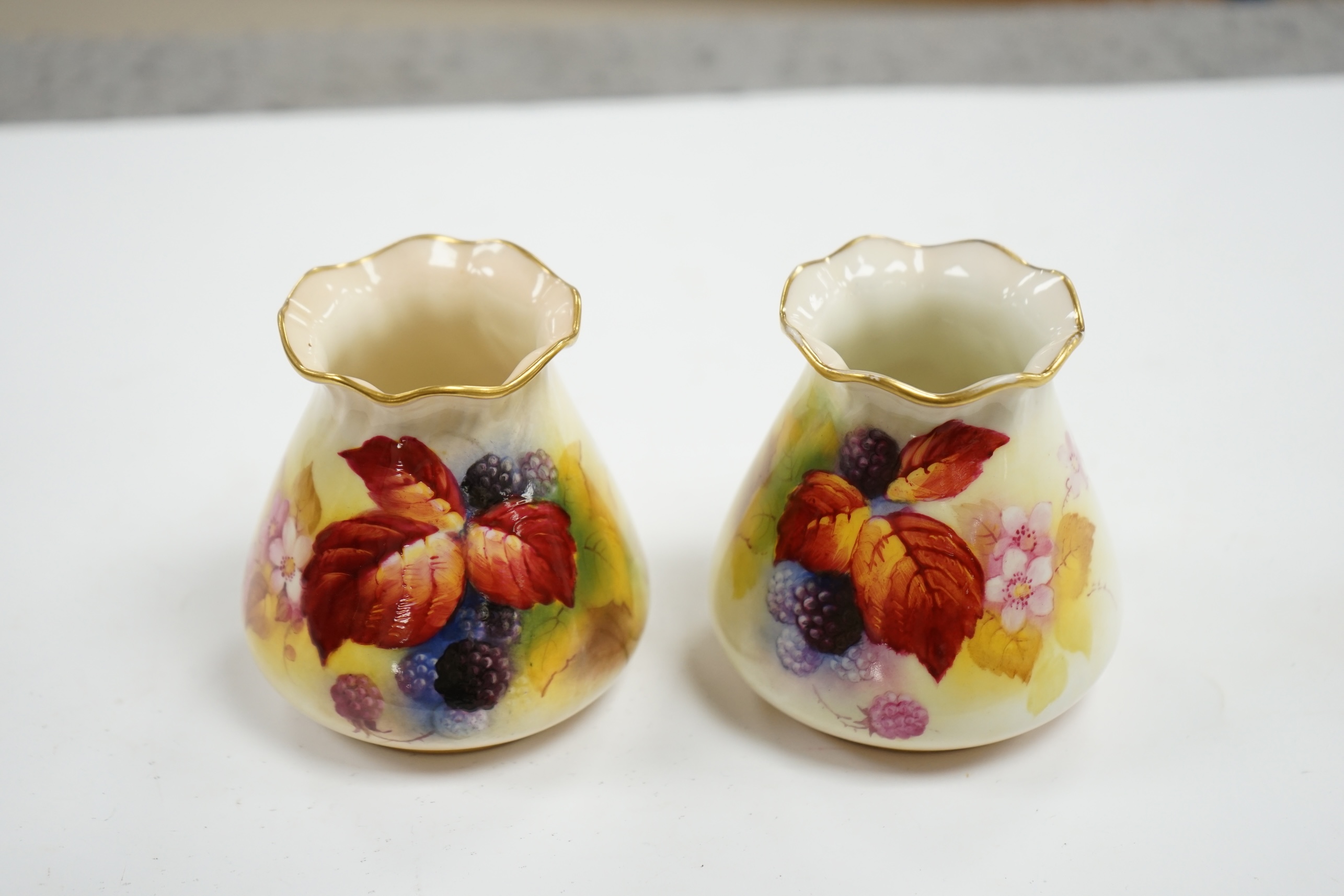 A pair of Worcester K. Blake pots, 8cm high. Condition - some gilding missing